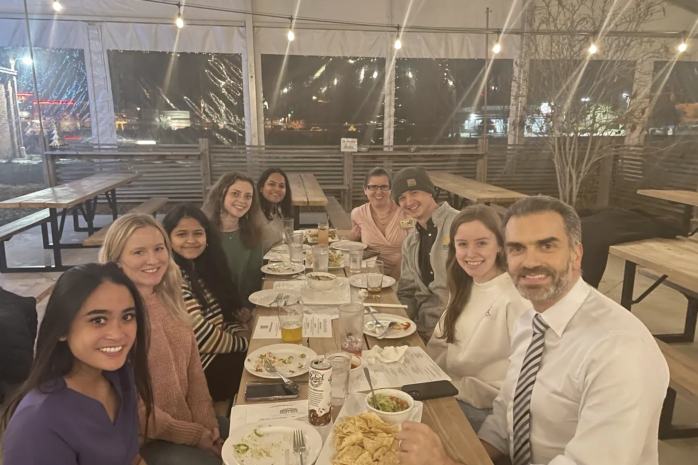 The team along a long table at an evening dinner
